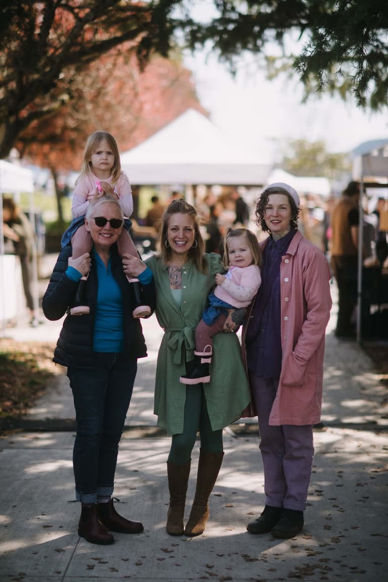 A family with two small children together at the Saturday market on Salt Spring Island
